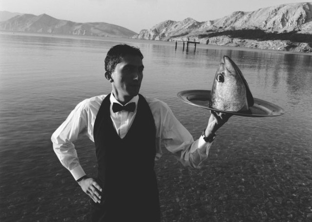 Waiter Serving Fish Head