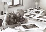Amy Conger - Portrait of Beaumont Newhall with Photographs
Click for more Images